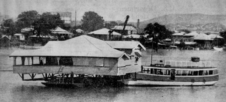 house being pushed by a tug boat down the Brisbane River
